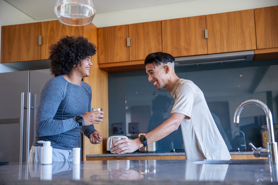 Friends Enjoying Laughter and Conversation in a Modern Kitchen