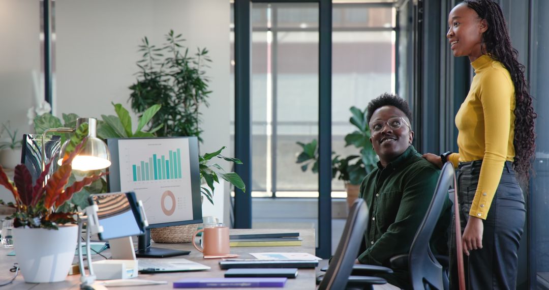 Colleagues Brainstorming in Modern Office with Data Charts