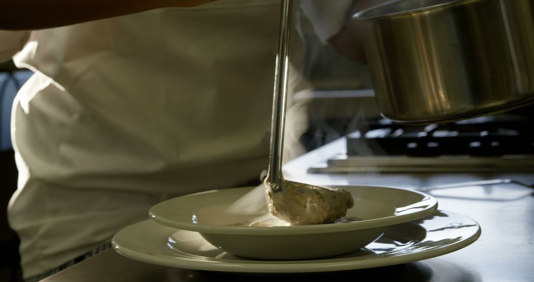 Chef Lovingly Serving Soup in Steamy Kitchen - Free Images, Stock Photos and Pictures on Pikwizard.com