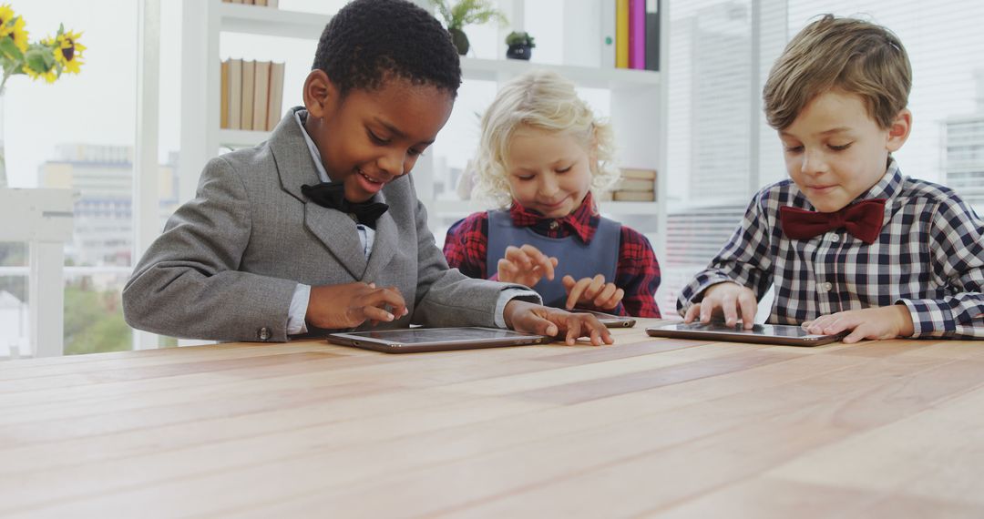 Children Using Tablets at Classroom Desk in Formal Attire - Free Images, Stock Photos and Pictures on Pikwizard.com