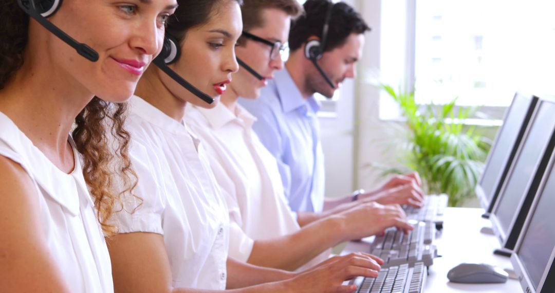 Call Center Team Typing and Assisting Customers at Desks