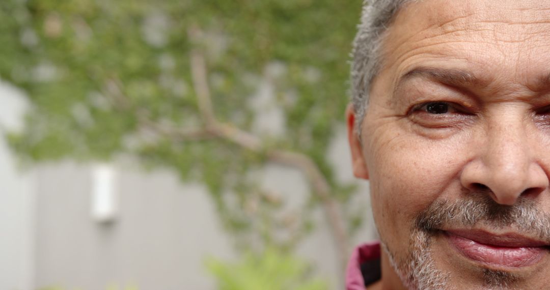 Serene Mature Man Partially Face View in Lush Courtyard