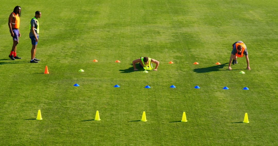 Athletes Training with Agility Cones on Grass Field - Free Images, Stock Photos and Pictures on Pikwizard.com