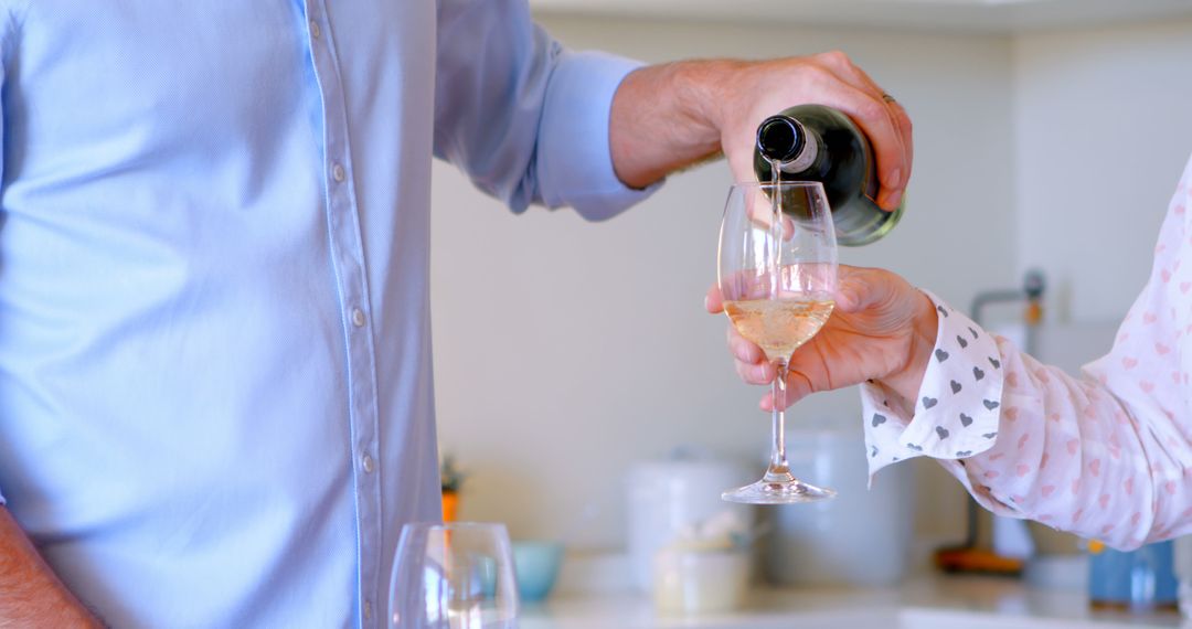 Man Pouring Wine into Glass at Home - Free Images, Stock Photos and Pictures on Pikwizard.com