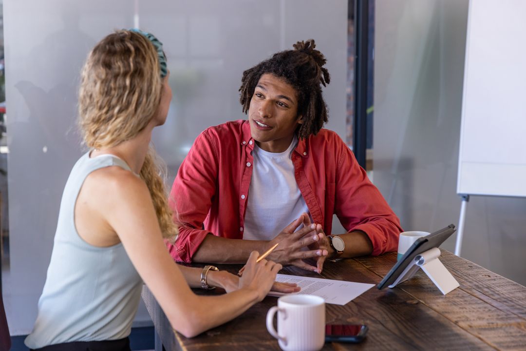 Diverse Colleagues Having Productive Discussion in Modern Meeting Environment