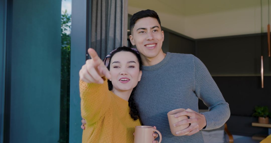 Couple Enjoying Morning Coffee While Admiring View
