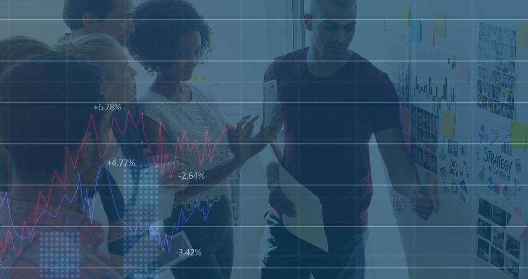 Diverse Team Analyzing Financial Data with Graphs on Screen