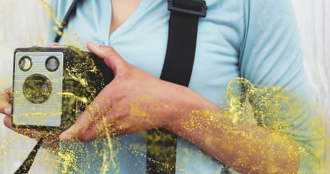 Woman Holding Vintage Box Camera with Artistic Yellow Effect