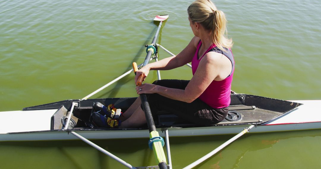 Woman Rowing Single Scull Boat in Tranquil Lake - Free Images, Stock Photos and Pictures on Pikwizard.com