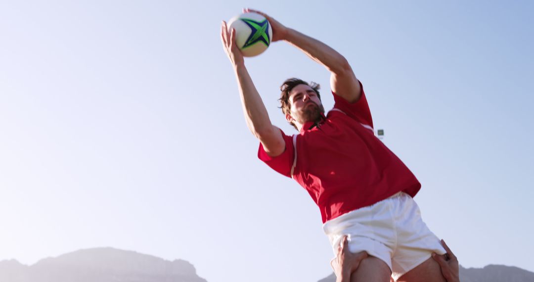 Rugby Player Catching Ball in Mid-Air During Match - Free Images, Stock Photos and Pictures on Pikwizard.com