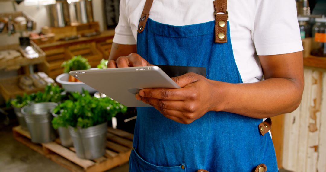 Small Business Owner Using Digital Tablet in Grocery Store - Free Images, Stock Photos and Pictures on Pikwizard.com