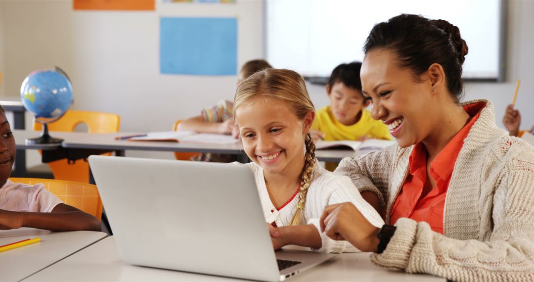 Teacher Guiding Young Student on Laptop in Classroom Setting - Free Images, Stock Photos and Pictures on Pikwizard.com