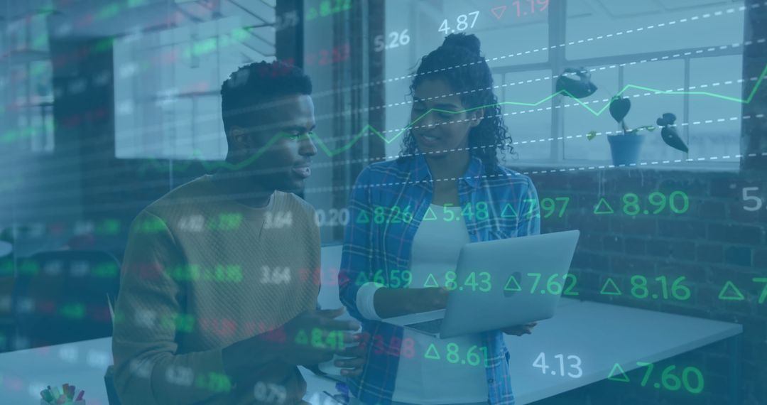 Diverse Colleagues Analyzing Financial Data Trends in Modern Office