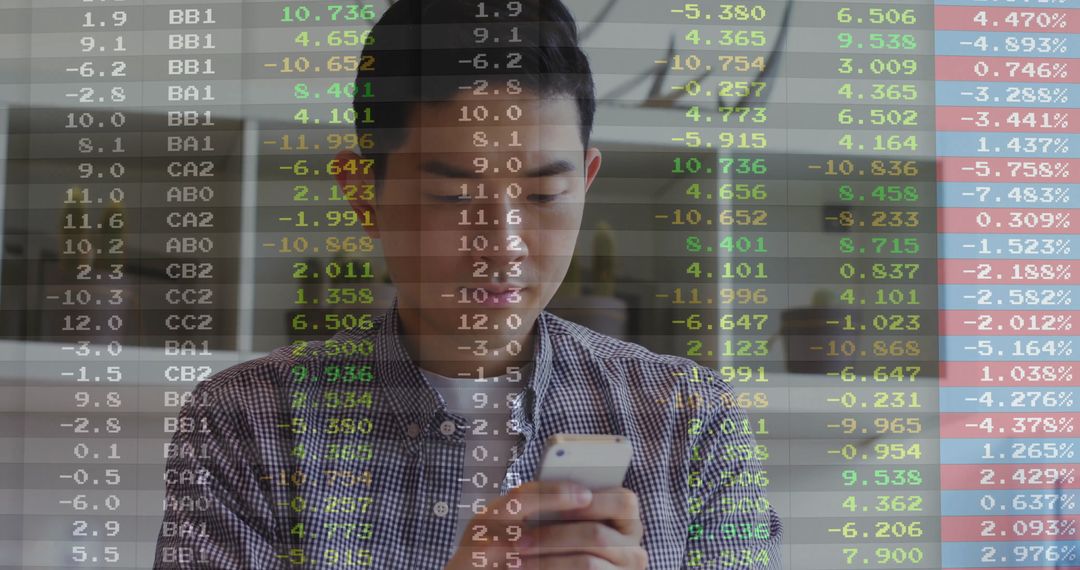 Asian Professional Monitoring Stock Data on Smartphone in Office Atmosphere
