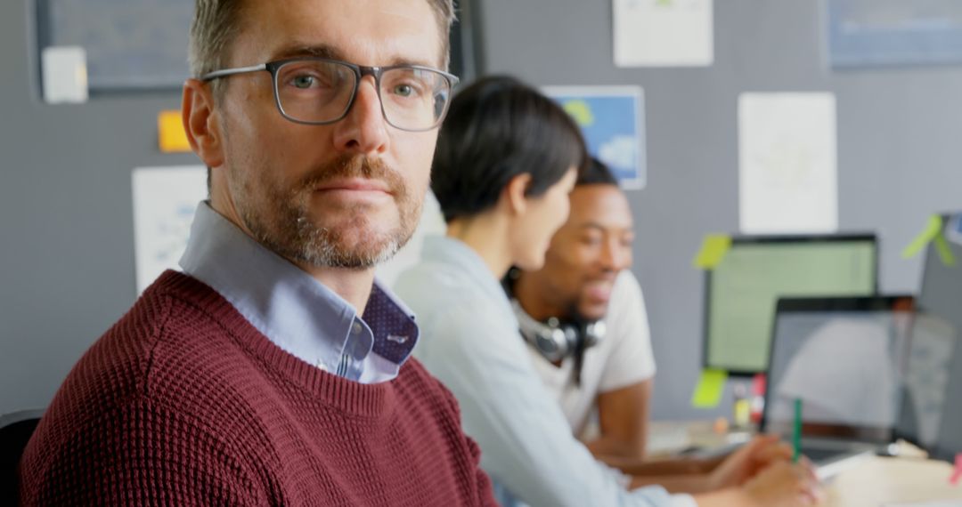Confident Male Executive with Diverse Team Working in Modern Office