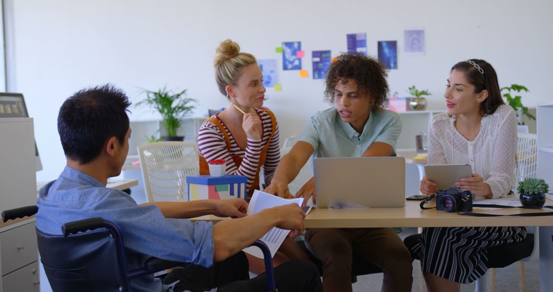 Diverse Team Engaged in Business Discussion in Modern Office