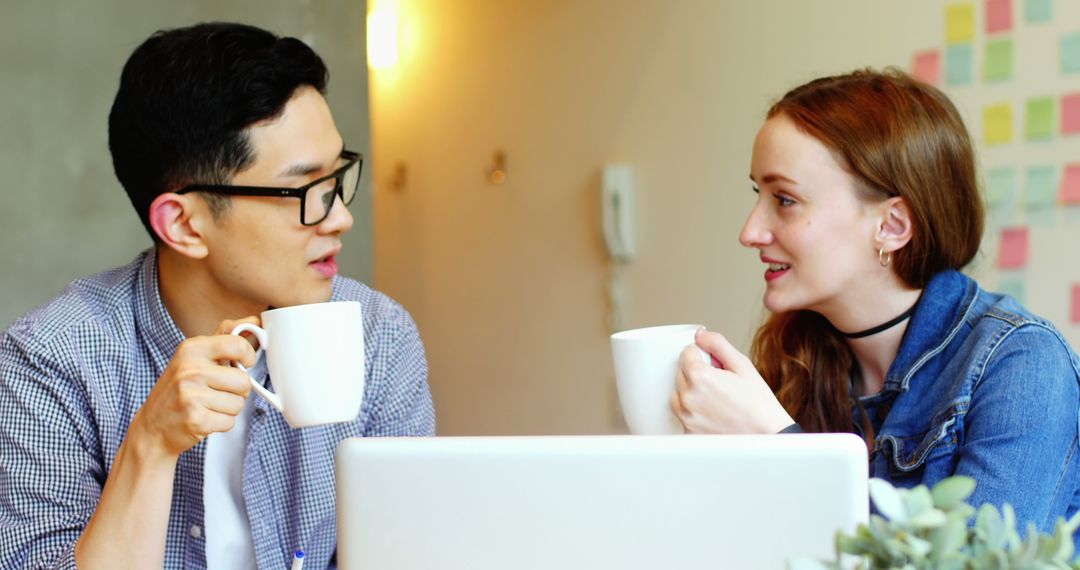 Two Colleagues Having Coffee Break in Office Setting
