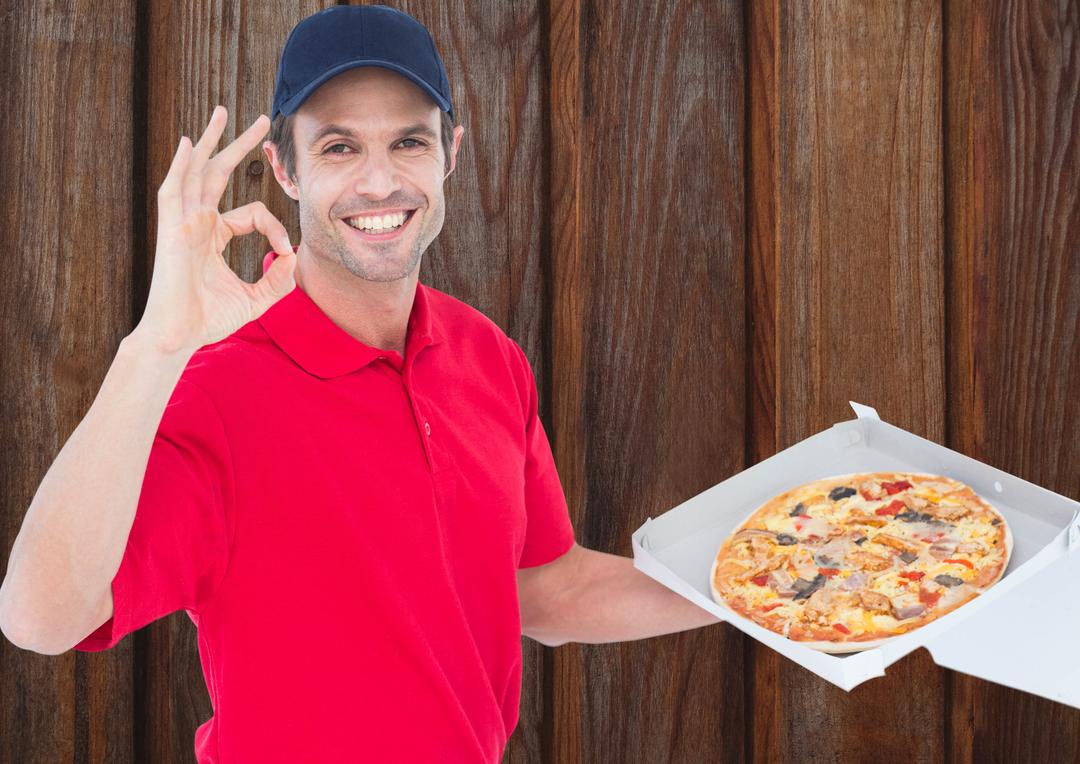 Happy Deliveryman Holding Pizza Box and Gesturing OK - Free Images, Stock Photos and Pictures on Pikwizard.com