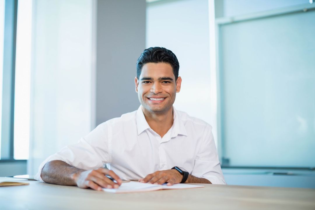 Smiling Professional Man Working at Office Desk