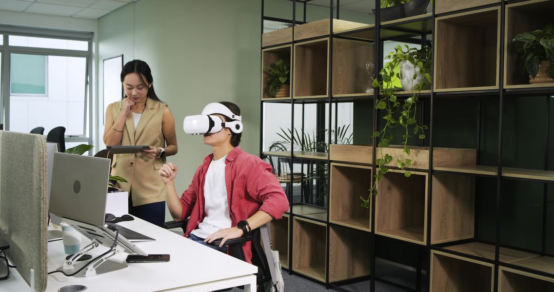 Coworkers Using VR Technology in a Modern Office