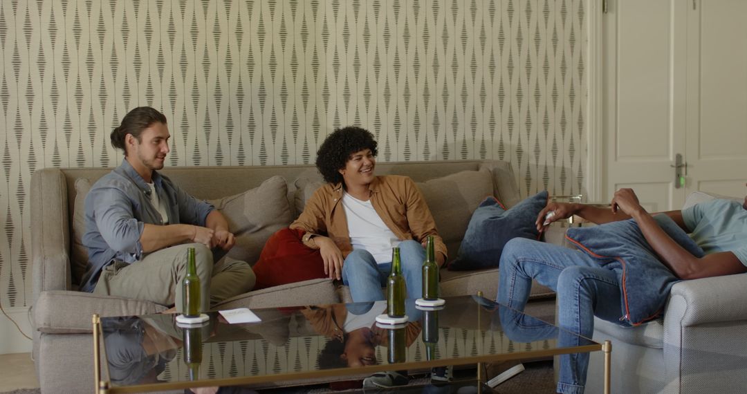 Friends Socializing on Sofa with Drinks and Laughter