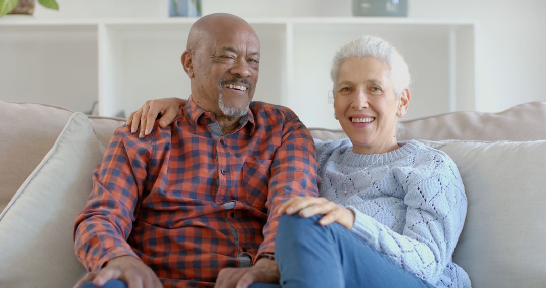 Happy Elderly Couple Relaxing at Home on Couch - Free Images, Stock Photos and Pictures on Pikwizard.com