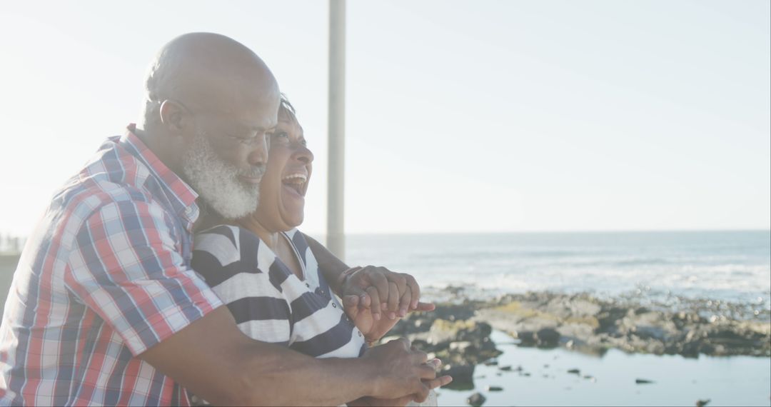 Senior Couple Embracing at Scenic Beach with Ocean View