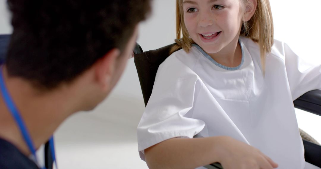 Smiling Pediatric Patient in Wheelchair During Medical Consultation