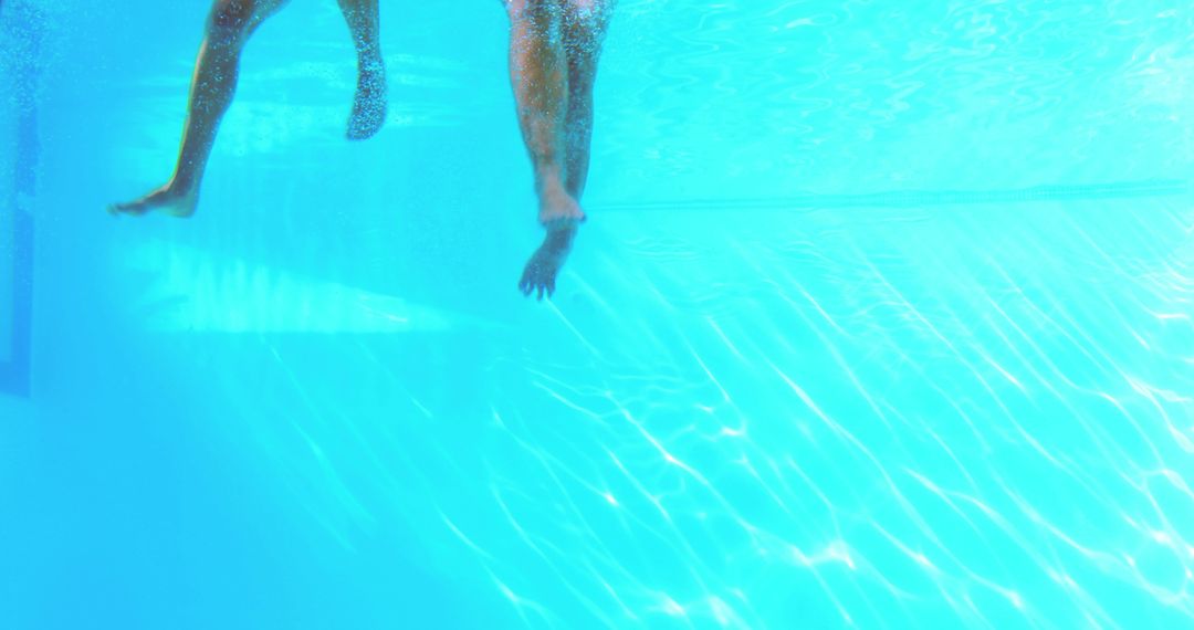 Underwater View of Swimmers' Legs in Pool - Free Images, Stock Photos and Pictures on Pikwizard.com