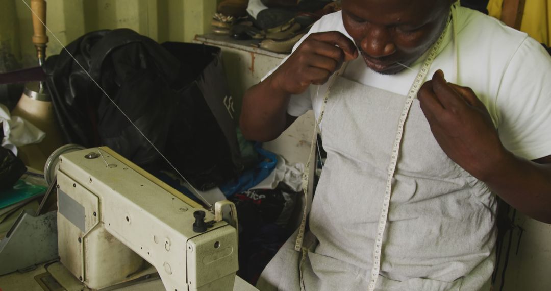 Tailor Measuring Fabric at Sewing Workshop