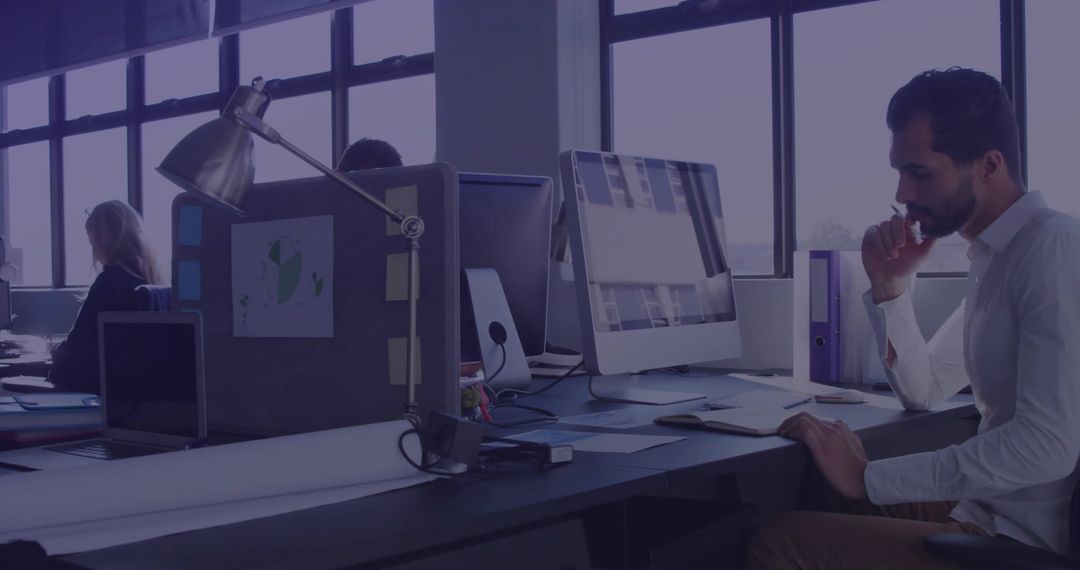 Focused Professional Man Concentrating in Modern Open Office