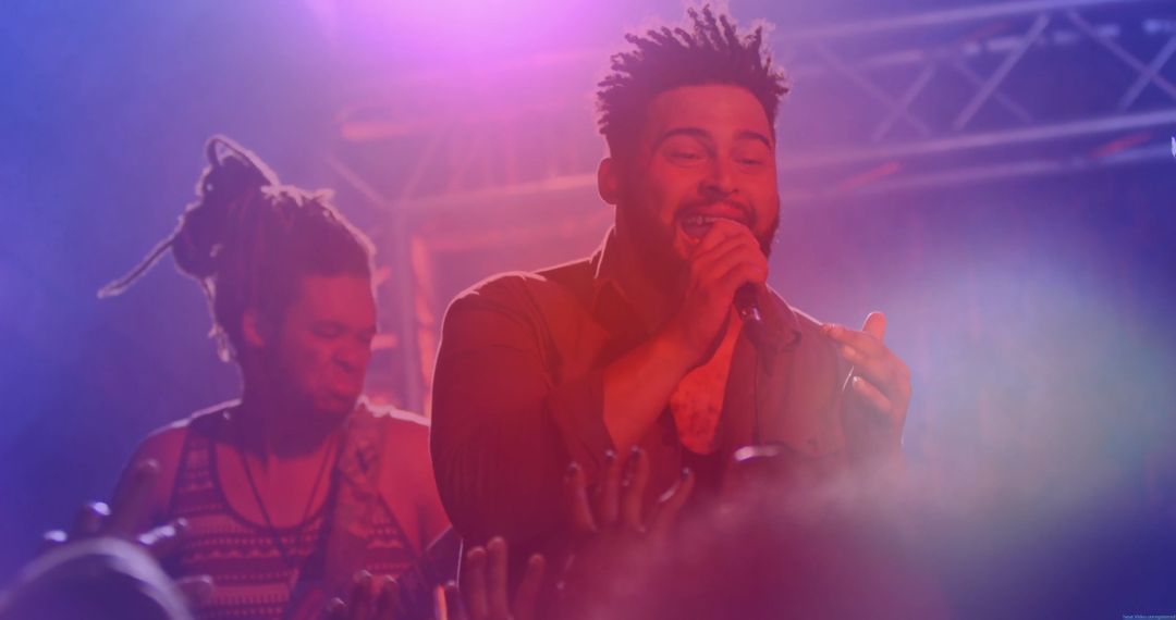 Dynamic Singer Entertaining Audience on Concert Stage