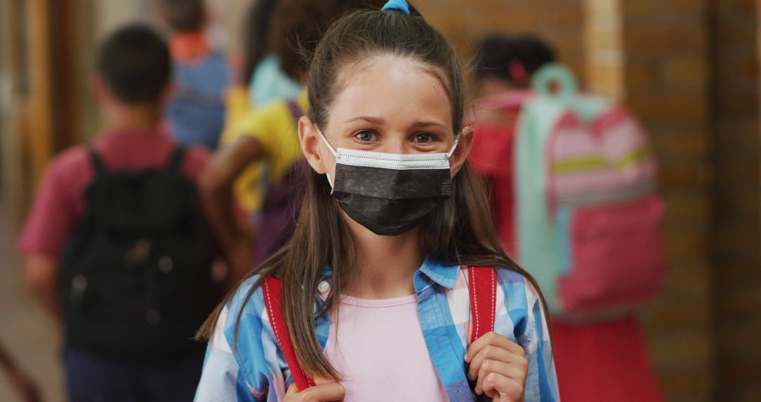 Portrait of caucasian schoolgirl wearing face mask, standing in corridor looking at camera - Free Images, Stock Photos and Pictures on Pikwizard.com