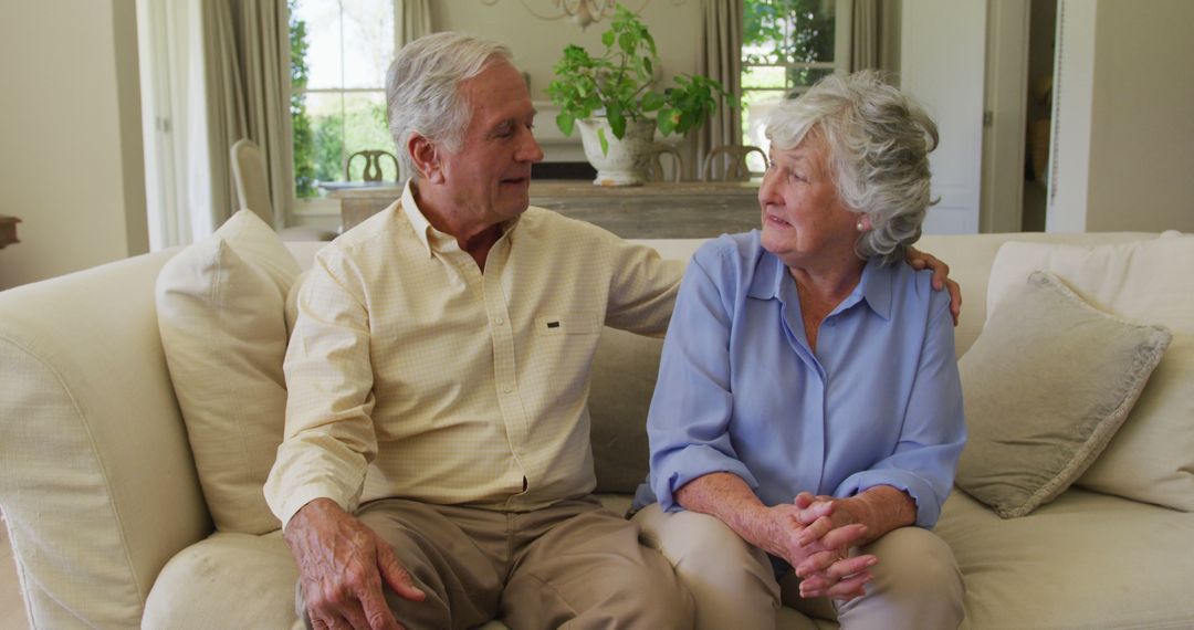 Portrait of smiling caucasian senior couple hugging each other while sitting on the couch at home - Free Images, Stock Photos and Pictures on Pikwizard.com