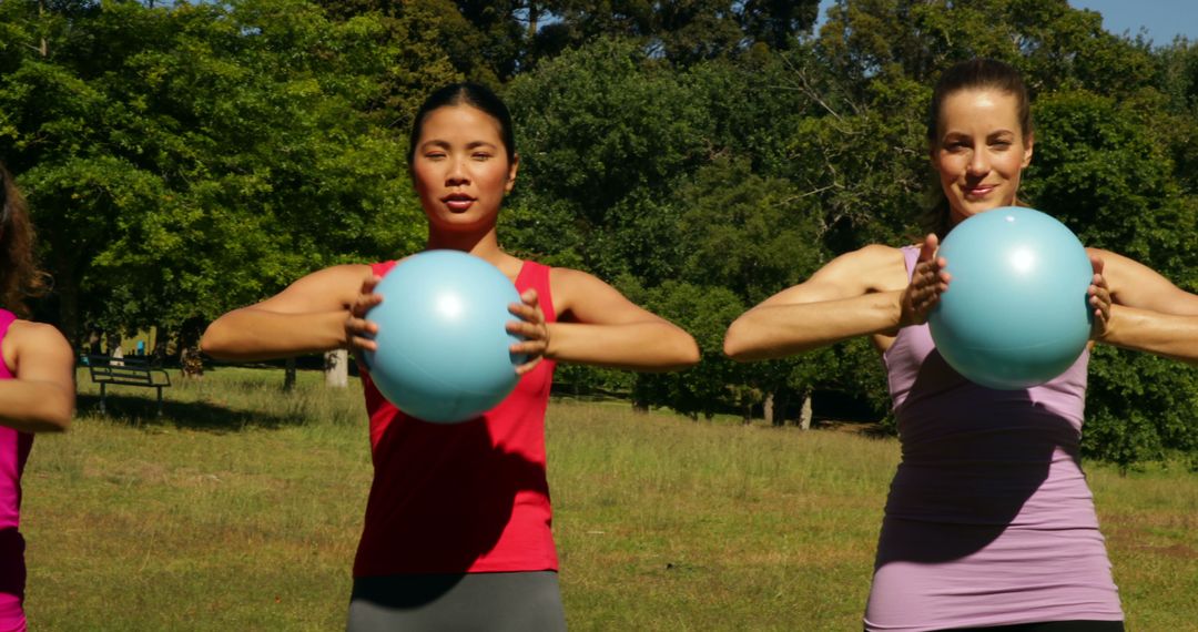 Fit Women Holding Fitness Balls During Outdoor Exercise - Free Images, Stock Photos and Pictures on Pikwizard.com