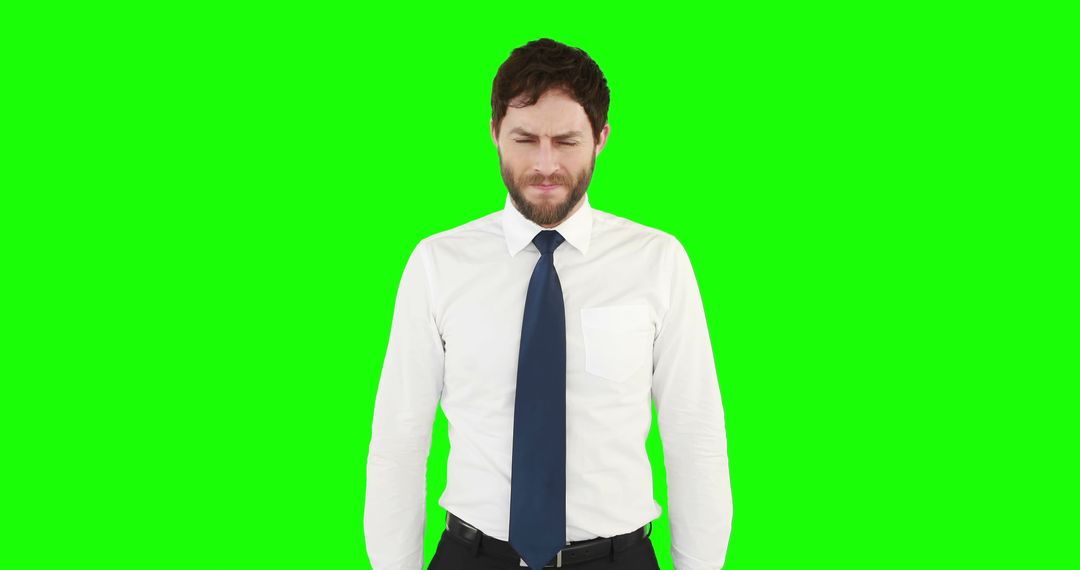 Businessman Making Uncomfortable Expression Against Green Screen Background - Free Images, Stock Photos and Pictures on Pikwizard.com