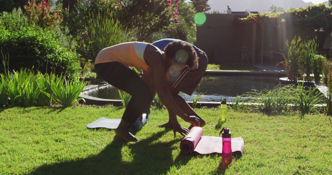 Couple Preparing Yoga Mats in Sunny Backyard - Free Images, Stock Photos and Pictures on Pikwizard.com