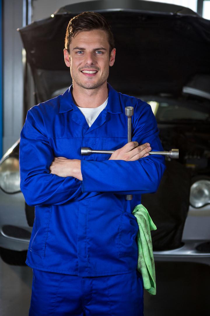 Portrait of mechanic holding lung wrench - Free Images, Stock Photos and Pictures on Pikwizard.com