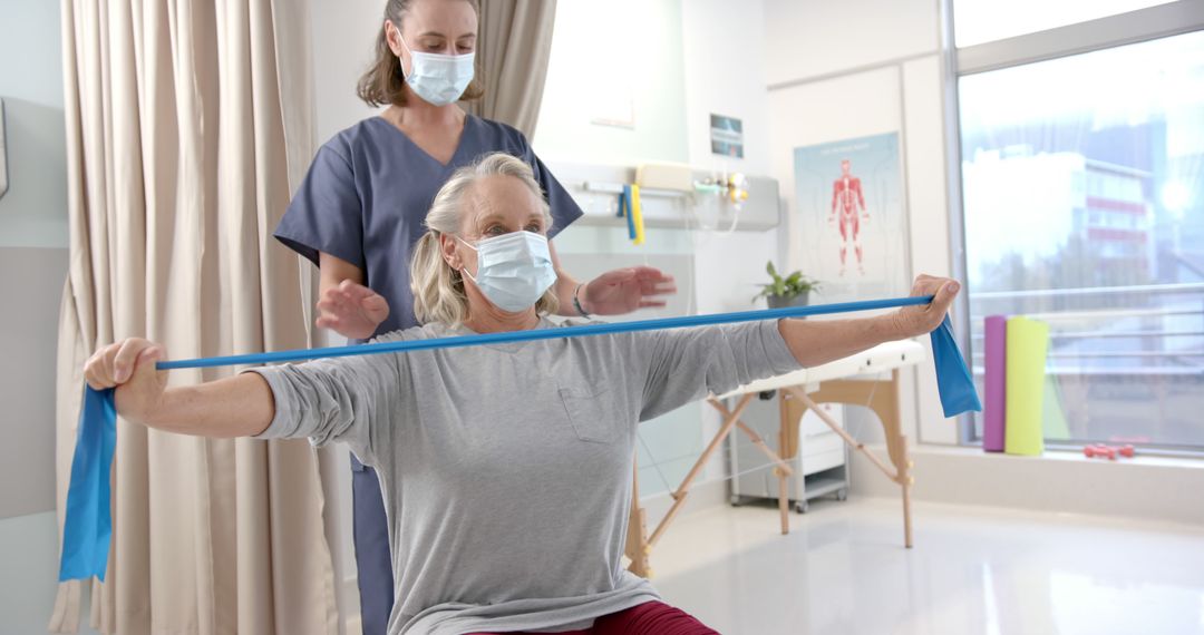 Elderly Woman Exercising with Physical Therapist Using Resistance Band - Free Images, Stock Photos and Pictures on Pikwizard.com