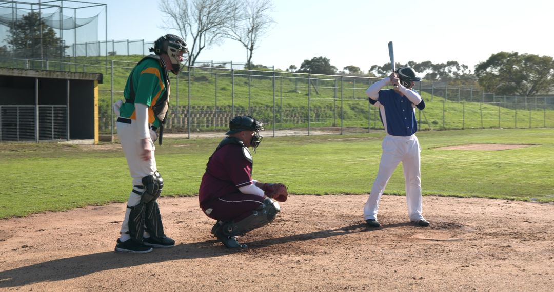 Male Baseball Players Engaging in Recreational Game on Local Field