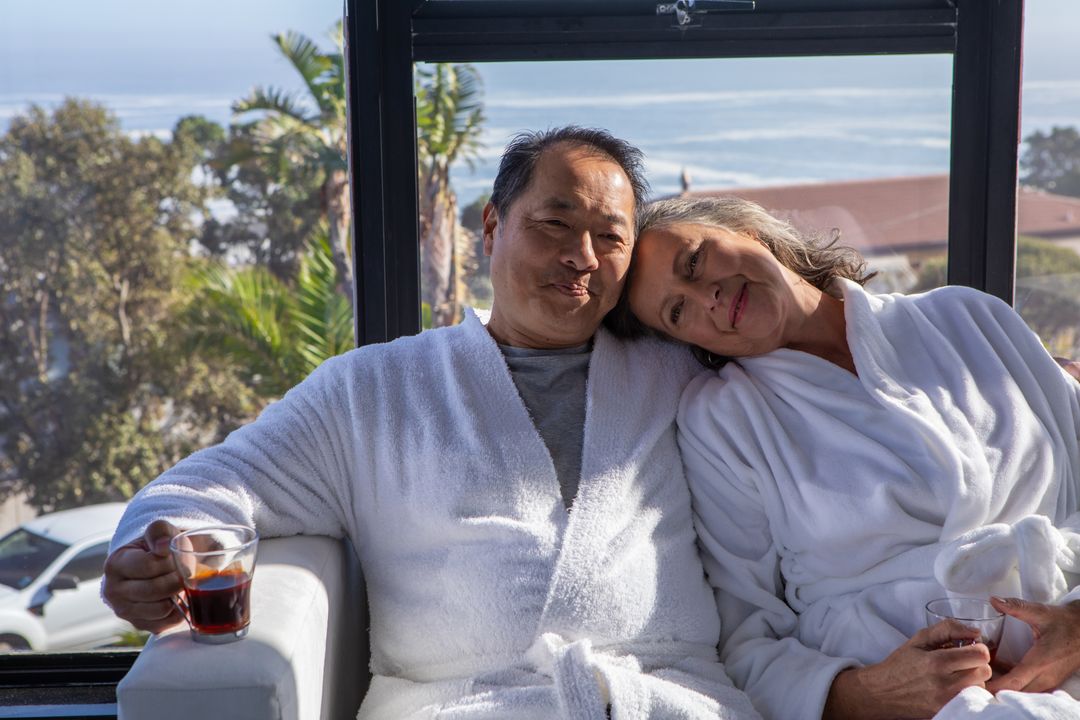 Senior Couple Relaxing in SPA over Tea with Scenic Coastal View
