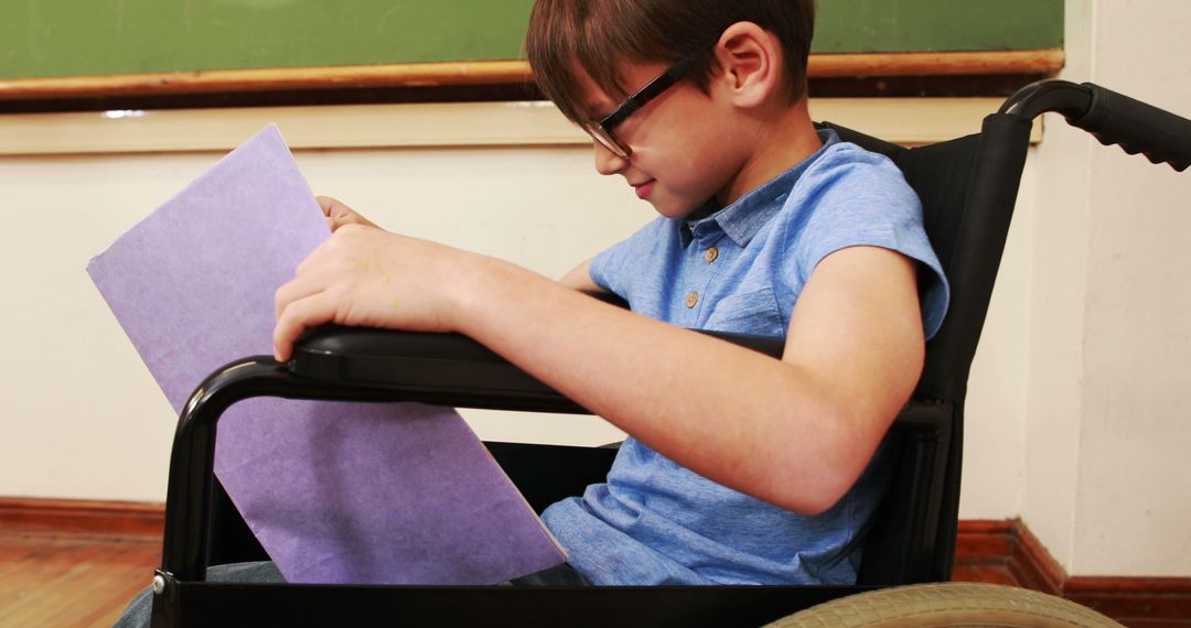 Boy in Wheelchair Reading Document in Classroom - Free Images, Stock Photos and Pictures on Pikwizard.com