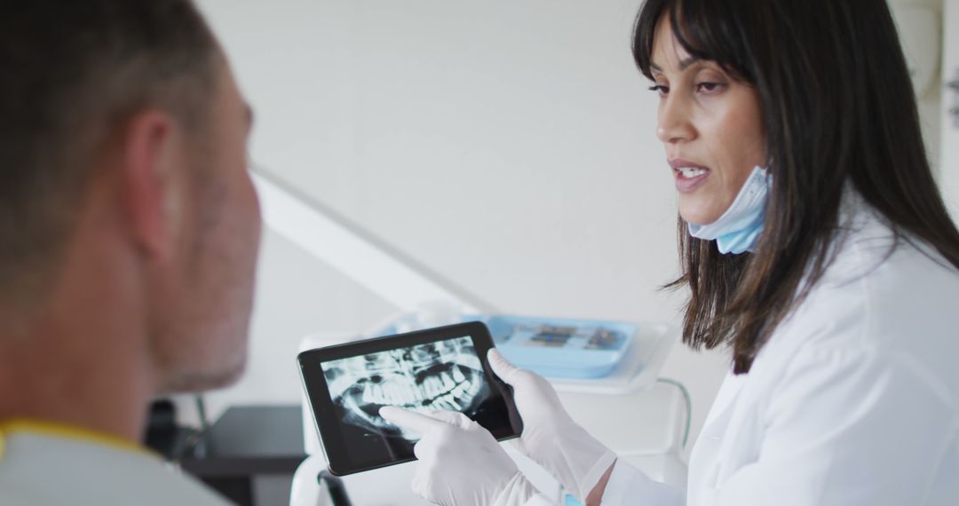 Dentist Explaining X-ray Results to Patient Using Tablet - Free Images, Stock Photos and Pictures on Pikwizard.com