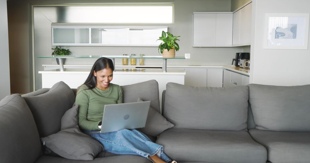 Smiling Woman Working on Laptop at Modern Home Lounge Area