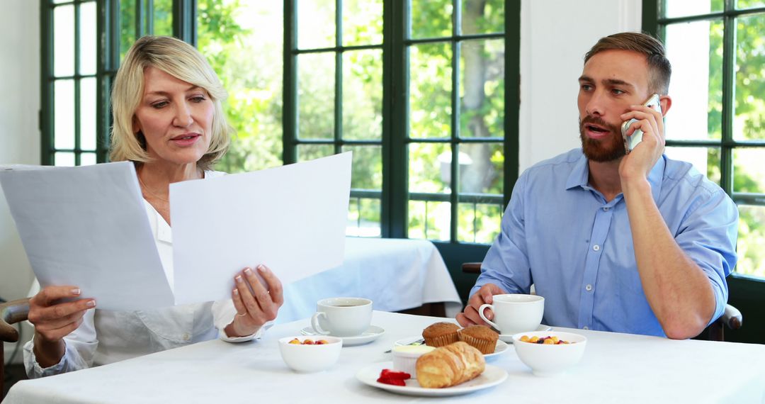 Business Meeting Over Breakfast Discussing Important Documents