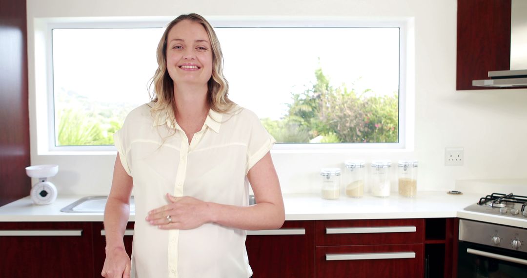 Pregnant Woman Smiling in Modern Kitchen - Free Images, Stock Photos and Pictures on Pikwizard.com