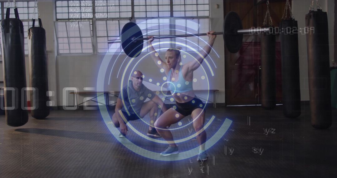 Athlete Performing Overhead Squat with Coach and HUD Overlay in Gym