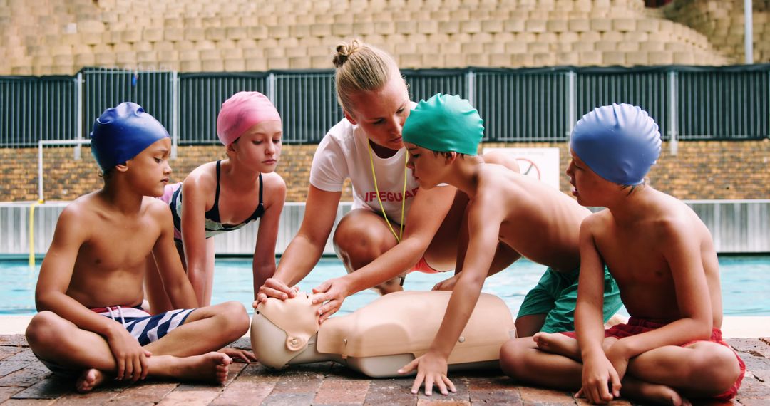 Lifeguard Teaching Kids CPR by Poolside - Free Images, Stock Photos and Pictures on Pikwizard.com