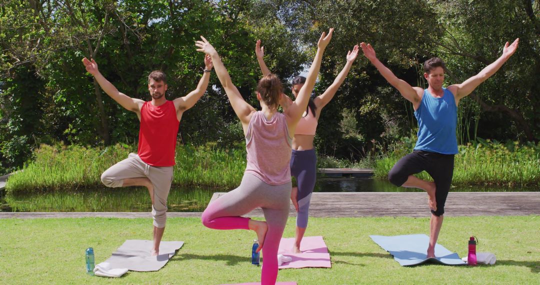 Group Yoga Practice in Park with Instructor Leading Tree Pose