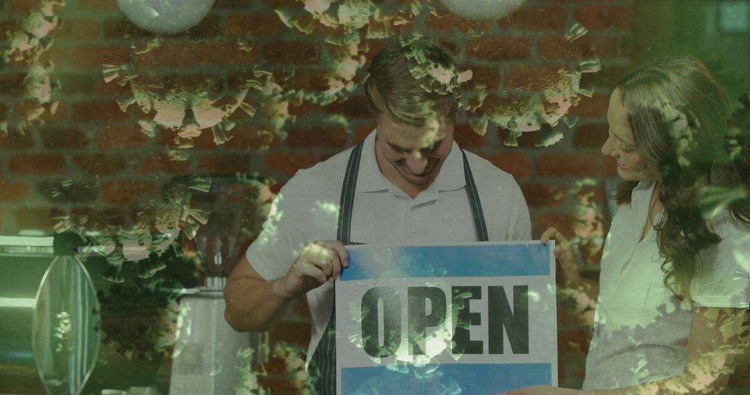 Small Business Owners Displaying Open Sign in Cafe